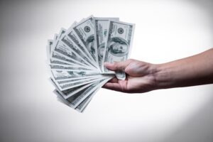 Hundred-dollar bills fanned out and held by a hand