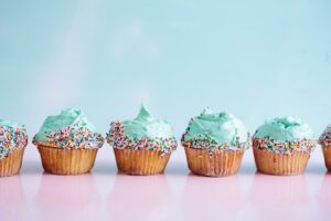 Blue-frosted cupcakes side by side