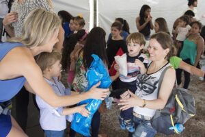 Two women in charitable setting holding babies