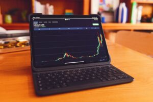 Laptop showing rising bar chart to denote growing value of domain names