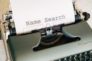Typewriter with words 'name search' on piece of paper to illustrate article about what makes a domain name