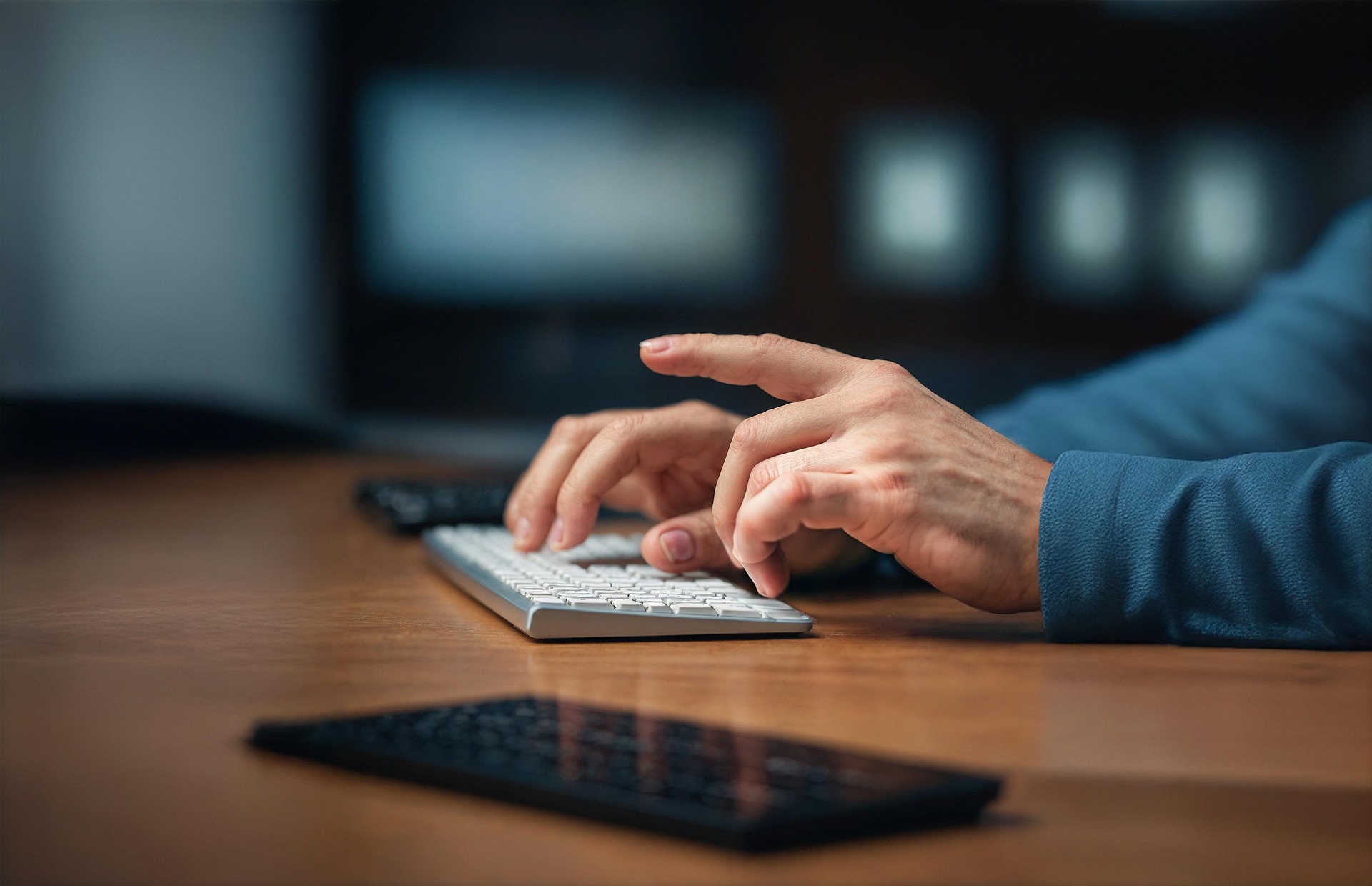 Close up of hands at a computer keyboard