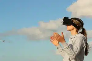 Woman standing outside wearing a VR headset